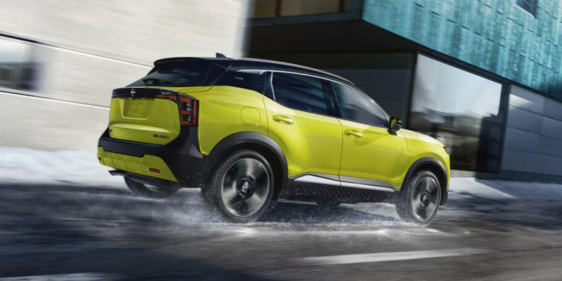 
Yellow Nissan Kicks driving on a wet road.